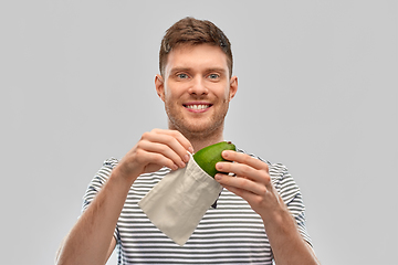 Image showing smiling man with avocado in reusable canvas bag