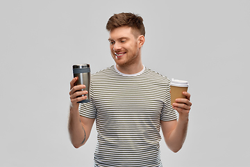 Image showing man comparing thermo cup or tumbler and coffee cup