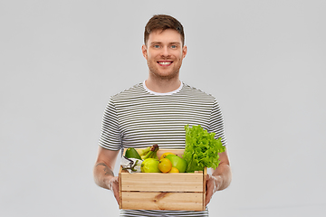 Image showing happy smiling man with food in wooden box