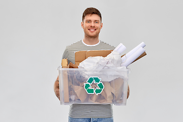 Image showing smiling young man sorting paper waste