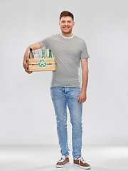 Image showing smiling young man sorting glass waste