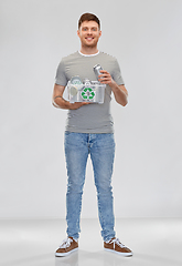 Image showing smiling young man sorting metallic waste