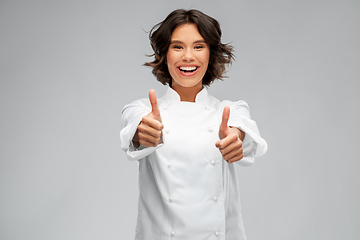 Image showing smiling female chef in toque showing thumbs up