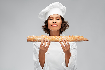 Image showing happy female chef with french bread or baguette