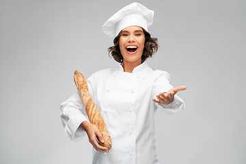Image showing happy female chef with french bread or baguette