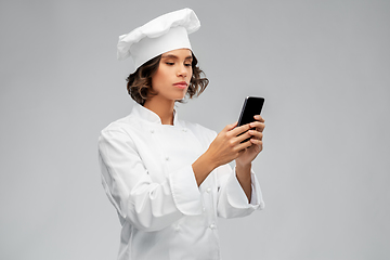 Image showing female chef in toque with smartphone