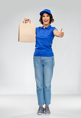 Image showing delivery woman with paper bag showing thumbs up