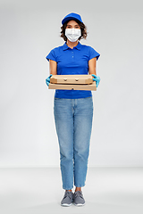 Image showing delivery woman in face mask with pizza boxes