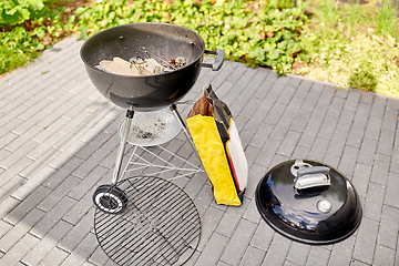 Image showing bbq grill brazier and bag of charcoal outdoors