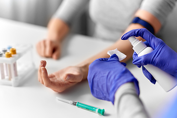 Image showing doctor and patient preparing for blood test