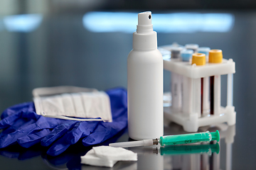 Image showing syringe, beakers with blood test, gloves and mask