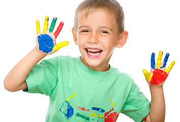 Image showing Portrait of a cute boy playing with paints