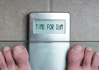 Image showing Man\'s feet on weight scale - Time for gym