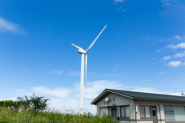 Image showing Wind turbine  and house