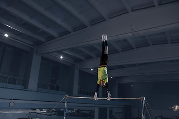 Image showing Little male gymnast training in gym, flexible and active