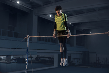 Image showing Little male gymnast training in gym, flexible and active