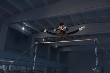 Image showing Little male gymnast training in gym, flexible and active