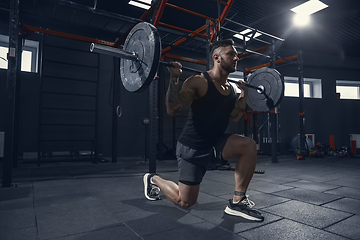 Image showing The male athlete training hard in the gym. Fitness and healthy life concept.