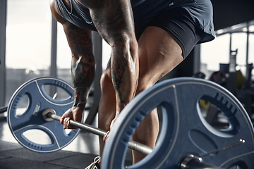 Image showing The male athlete training hard in the gym. Fitness and healthy life concept.