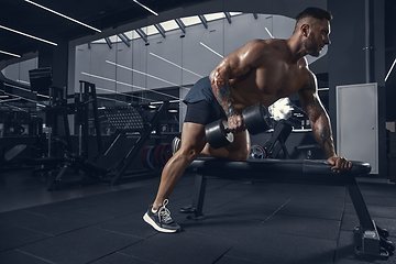 Image showing The male athlete training hard in the gym. Fitness and healthy life concept.