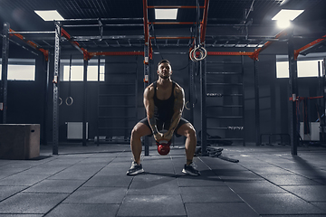 Image showing The male athlete training hard in the gym. Fitness and healthy life concept.