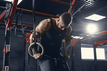 Image showing The male athlete training hard in the gym. Fitness and healthy life concept.