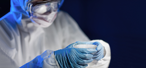 Image showing close up of scientist with chemical in petri dish