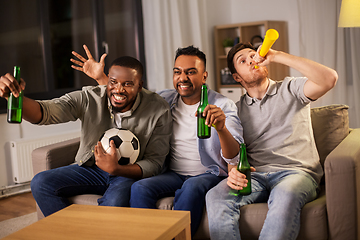 Image showing friends or soccer fans with ball and beer at home