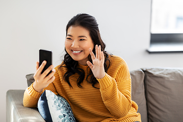 Image showing woman with smartphone having video call at home