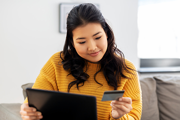 Image showing asian woman with tablet pc and credit card at home