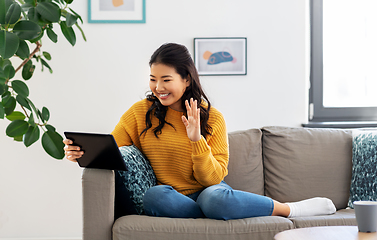 Image showing woman with tablet pc having video call at home