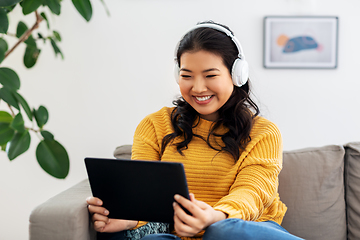 Image showing asian woman with headphones and tablet pc at home