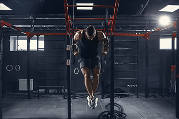 Image showing The male athlete training hard in the gym. Fitness and healthy life concept.