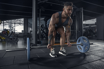 Image showing The male athlete training hard in the gym. Fitness and healthy life concept.