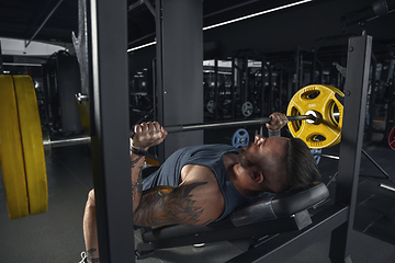 Image showing The male athlete training hard in the gym. Fitness and healthy life concept.