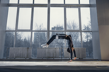 Image showing Little male gymnast training in gym, flexible and active