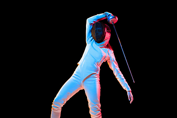 Image showing Teen girl in fencing costume with sword in hand isolated on black background