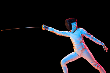 Image showing Teen girl in fencing costume with sword in hand isolated on black background