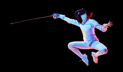 Image showing Teen girl in fencing costume with sword in hand isolated on black background