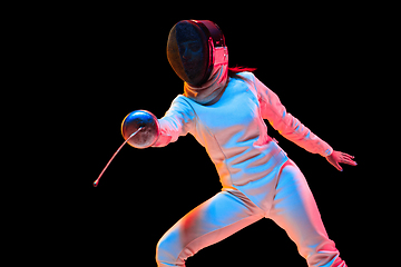 Image showing Teen girl in fencing costume with sword in hand isolated on black background