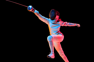 Image showing Teen girl in fencing costume with sword in hand isolated on black background