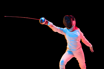 Image showing Teen girl in fencing costume with sword in hand isolated on black background