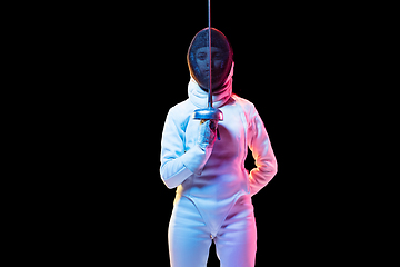 Image showing Teen girl in fencing costume with sword in hand isolated on black background