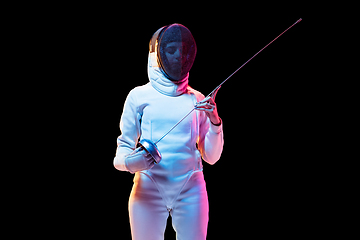 Image showing Teen girl in fencing costume with sword in hand isolated on black background