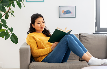 Image showing asian young woman reading book at home