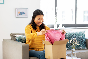 Image showing happy asian young woman with parcel box at home