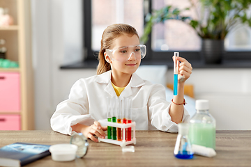 Image showing girl with test tube studying chemistry at home