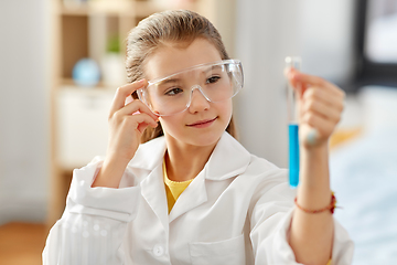 Image showing girl with test tube studying chemistry at home