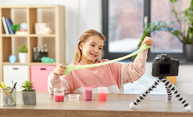 Image showing girl with slime and camera video blogging at home