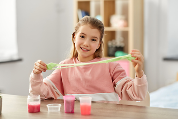 Image showing girl playing with slime at home